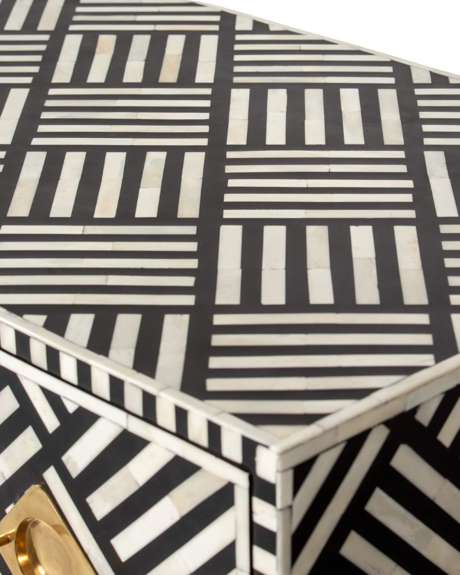 Luxury black and white bone inlay chest of drawers with brass accents and geometric design, handcrafted for statement interiors.