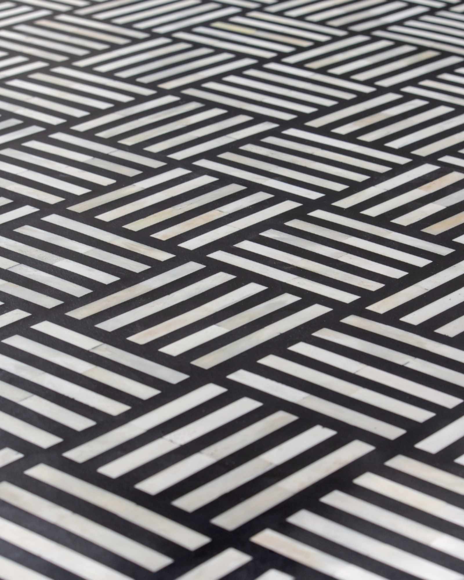 Luxury black and white bone inlay chest of drawers with brass accents and geometric design, handcrafted for statement interiors.