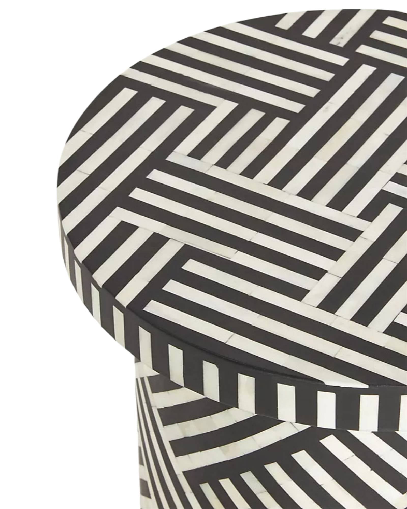Black bone inlay side table with bold striped pattern, handcrafted with a brass base accent, ideal for modern interiors.