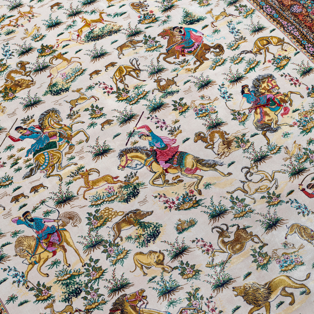 Silk Persian rug with an ivory base, colorful hunting scene, and a detailed border in plum, gold, teal, and indigo floral patterns.