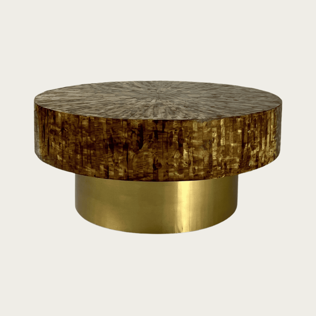 Round brown mother of pearl inlay coffee table with a rich textured surface and bold gold base. A luxurious centerpiece for living spaces.