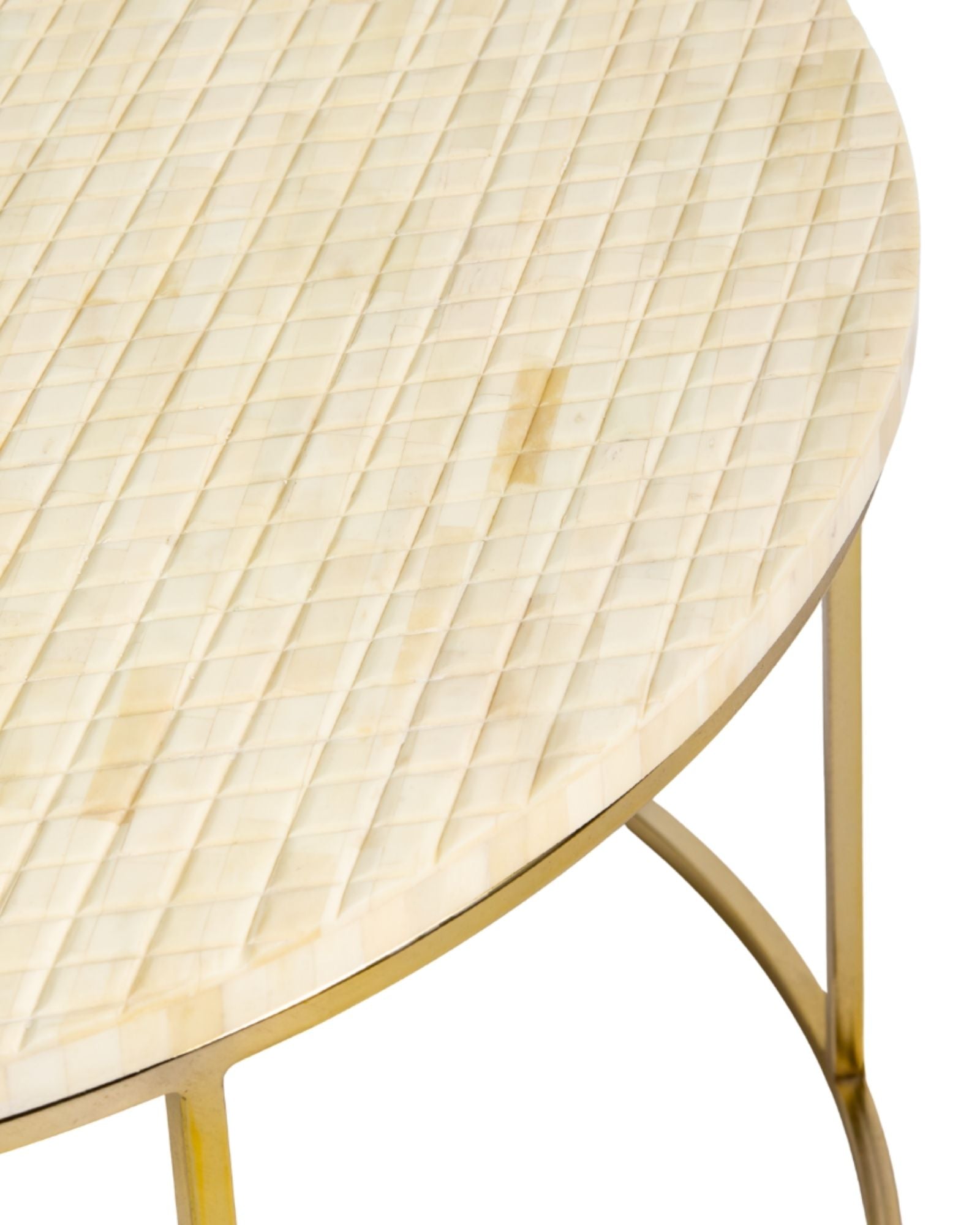 Ivory bone carved coffee table with linear textured design and brushed gold circular metal base by Tabeer Homes.