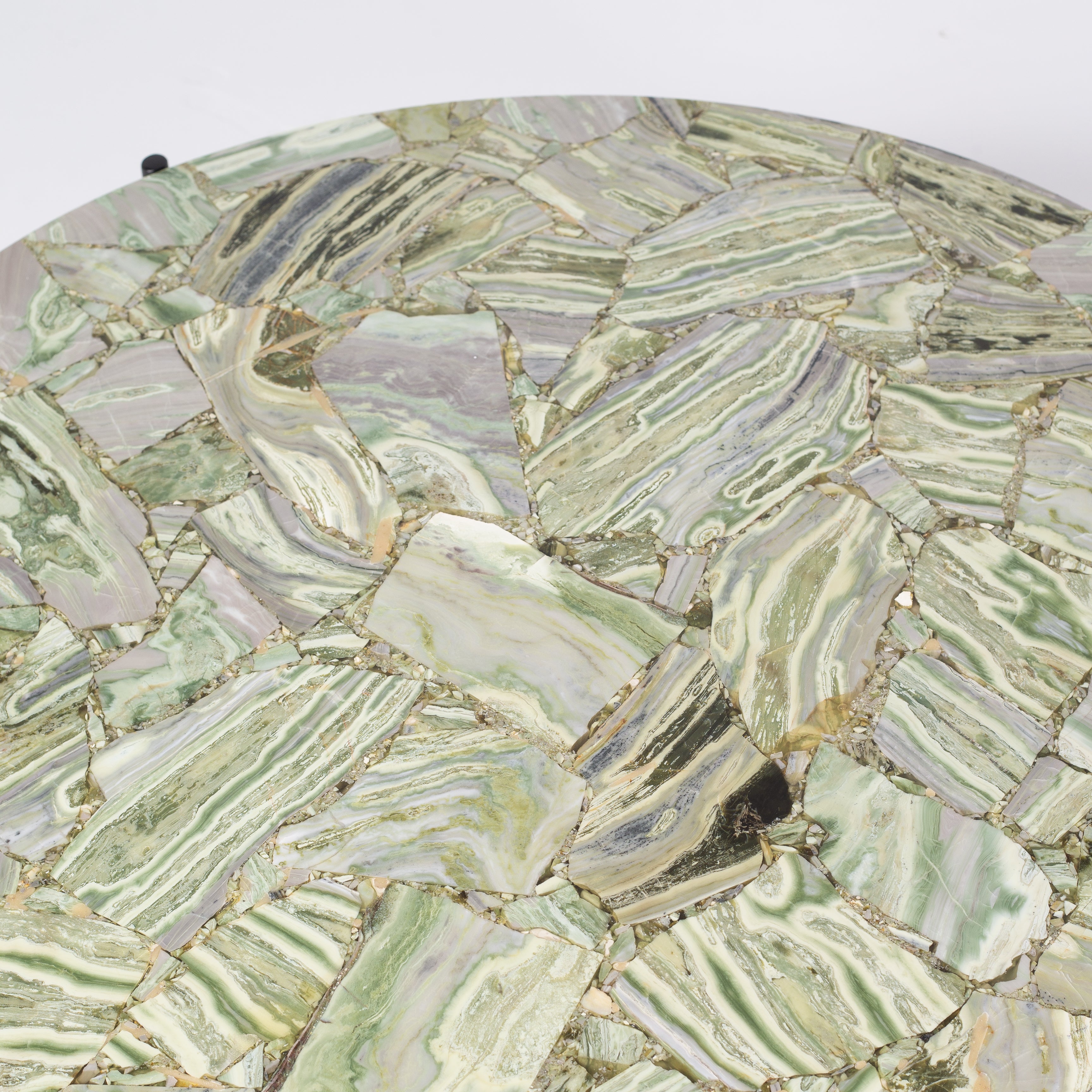 Handcrafted agate coffee table with round stone top and black metal base, artisan-made heritage piece.