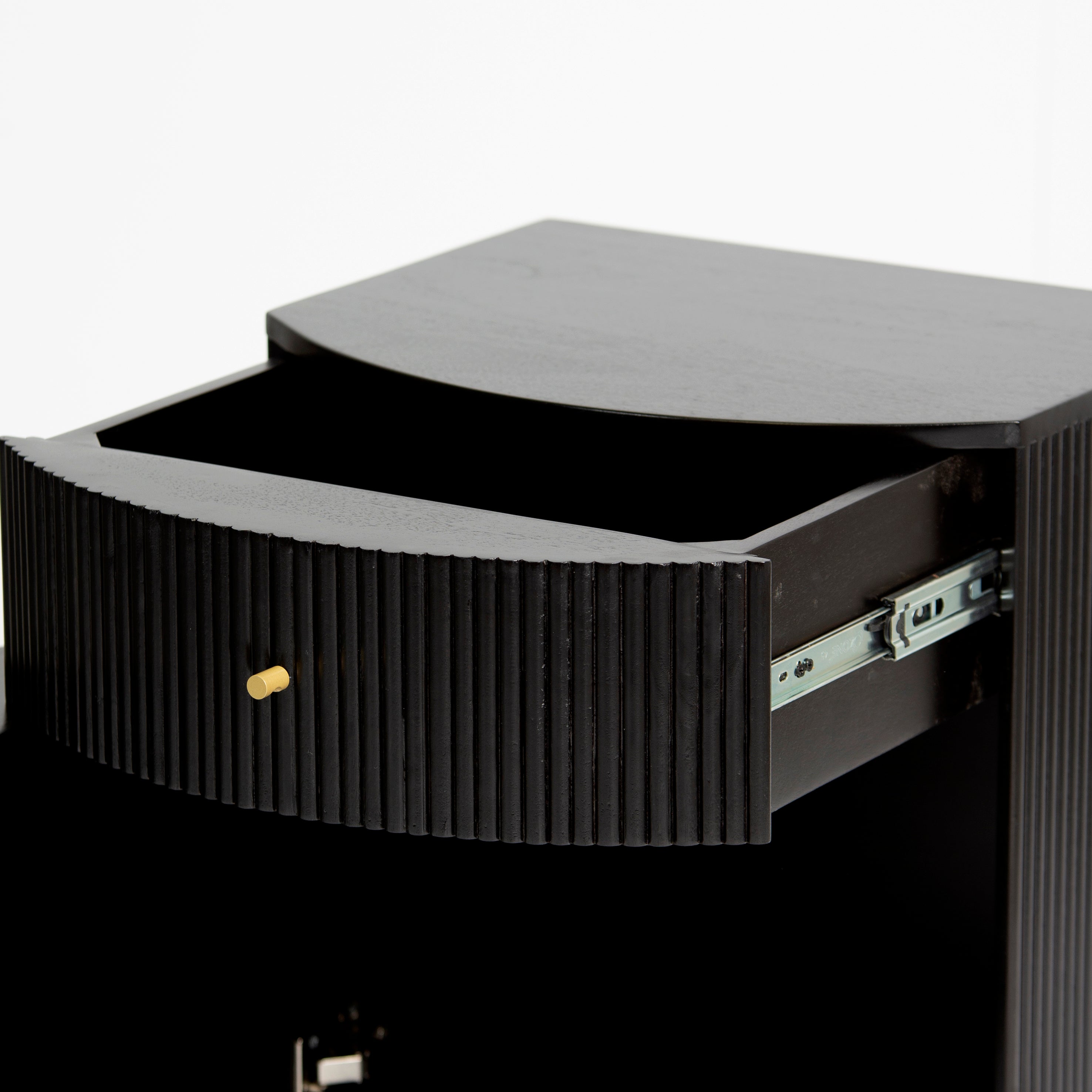 Wooden side drawer featuring fluted texture in black with brass accents, handcrafted furniture piece