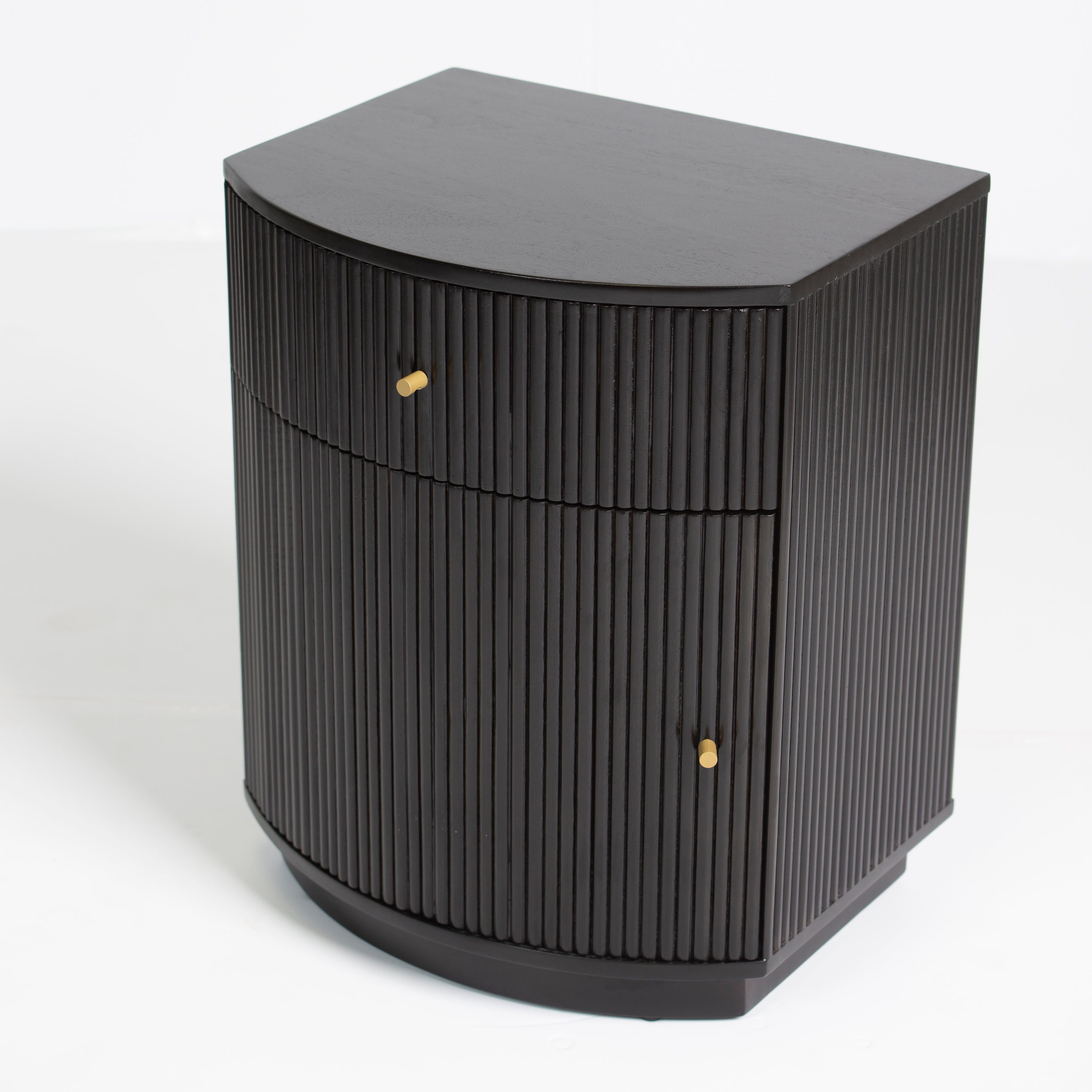 Wooden side drawer featuring fluted texture in black with brass accents, handcrafted furniture piece