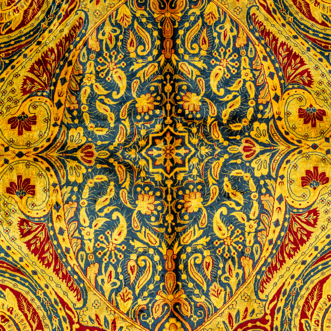 Golden silk rug with navy and red paisley floral detailing, handcrafted in a luxurious sheen finish with traditional Persian design elements.