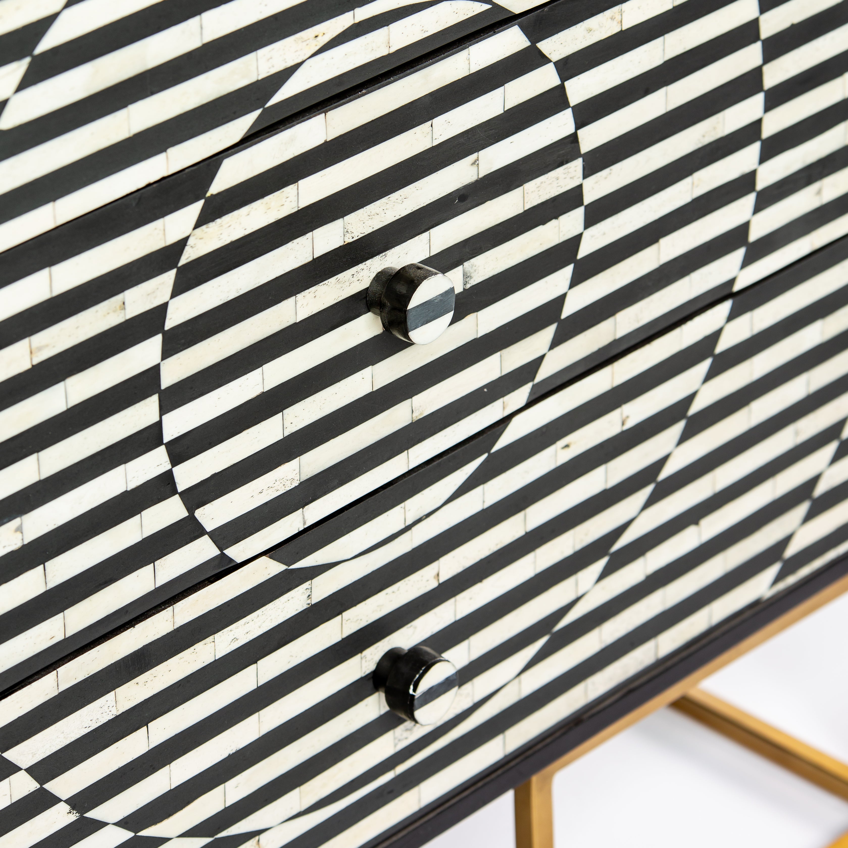 Black and white geometric bone inlay chest of drawers with gold base