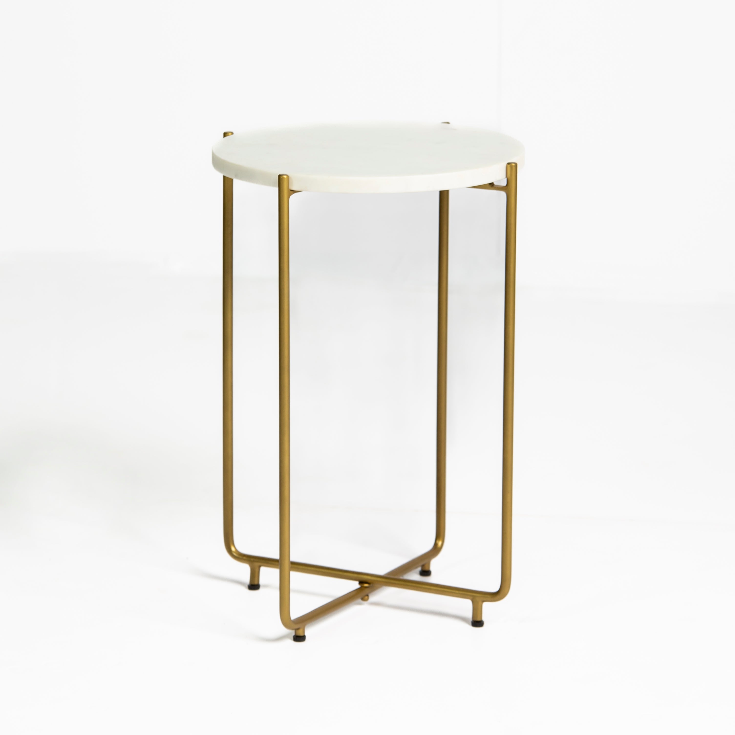 Marble side table featuring round white top with brass metal base, handcrafted furniture piece