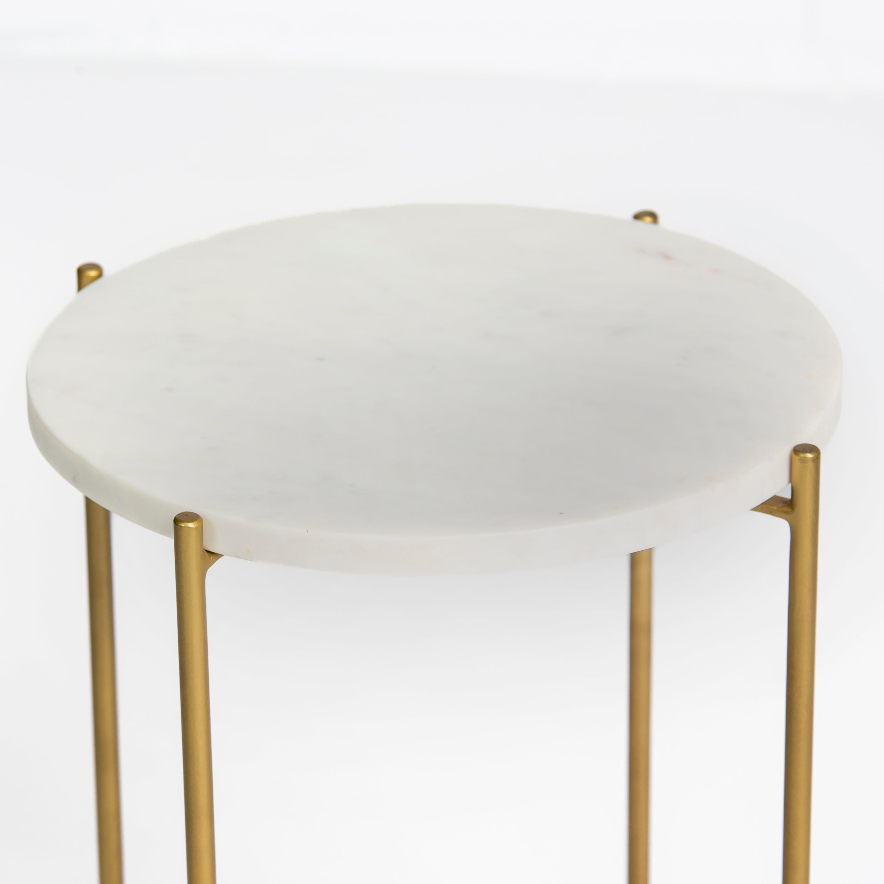 Marble side table featuring round white top with brass metal base, handcrafted furniture piece