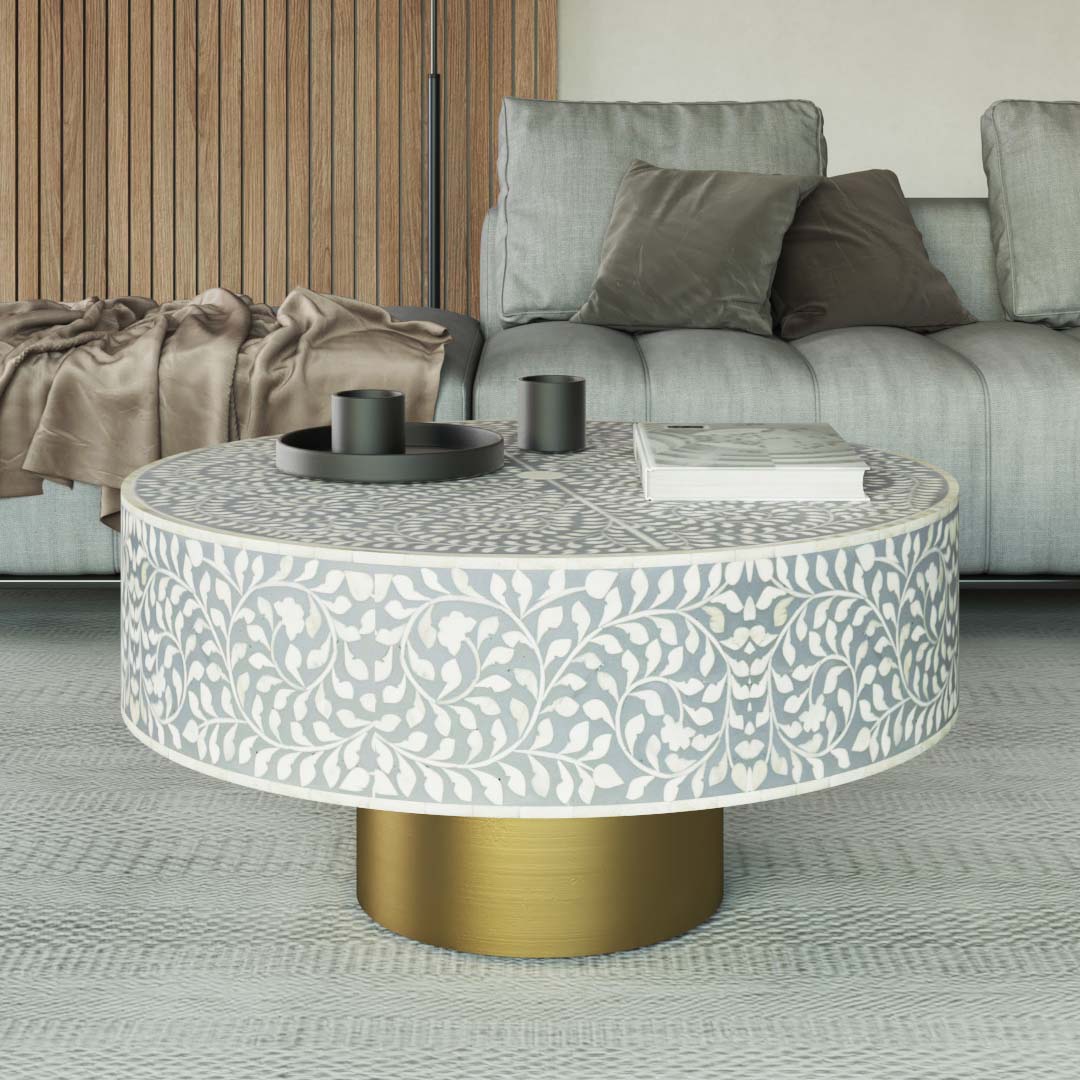 Round grey bone inlay coffee table with floral design and a gold base. Perfect for modern or elegant living room decor.