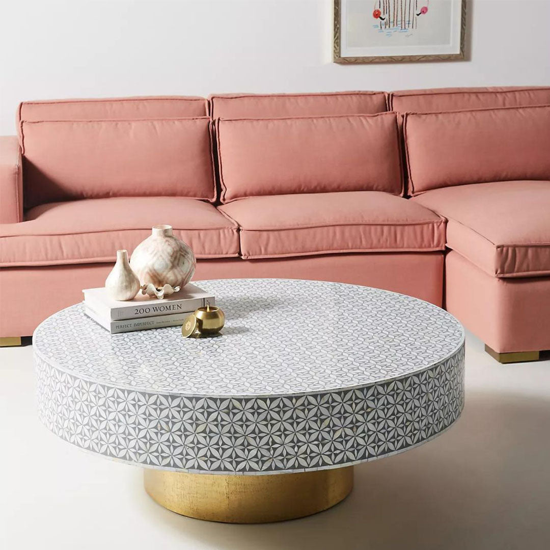 Round grey bone inlay coffee table with floral design and a bold gold base. A stylish and modern centerpiece for any living room.
