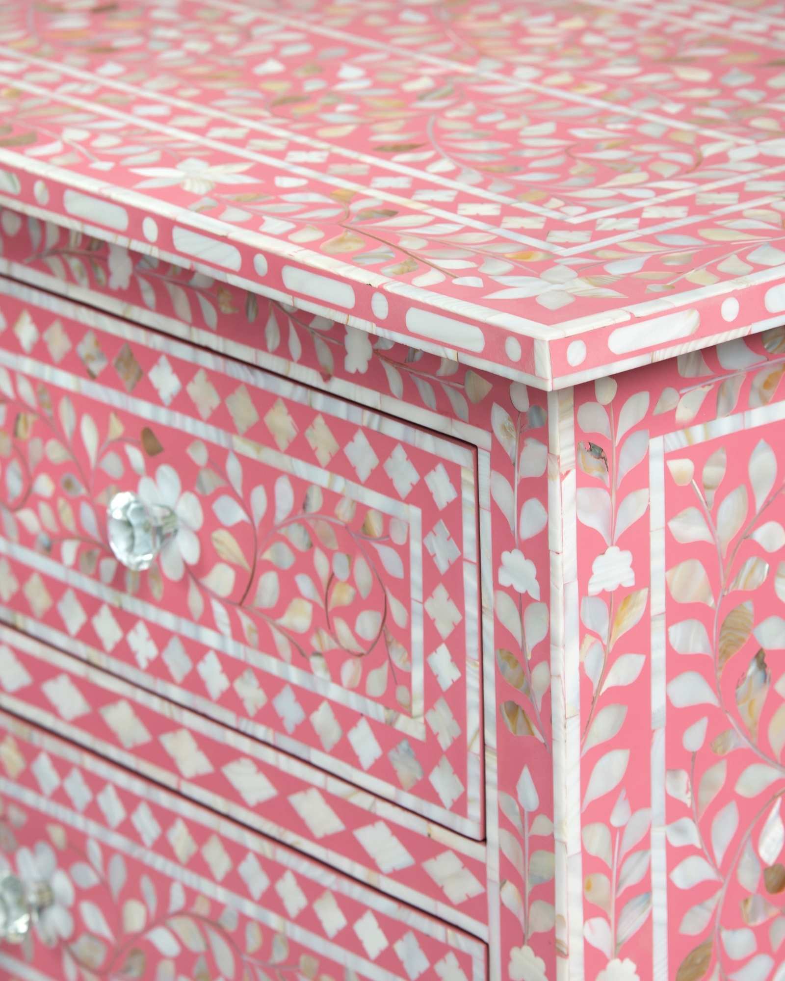 Mother of pearl inlay chest of drawers featuring intricate floral pattern in pink and white, handcrafted furniture piece