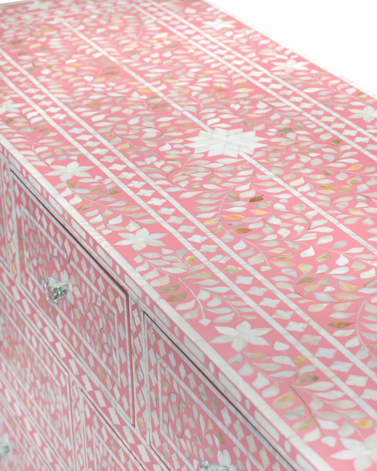 Mother of pearl inlay chest of drawers featuring intricate floral pattern in pink and white, handcrafted furniture piece