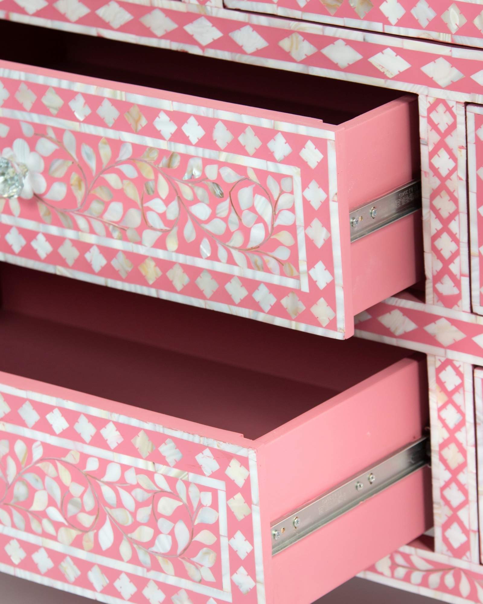 Mother of pearl inlay chest of drawers featuring intricate floral pattern in pink and white, handcrafted furniture piece