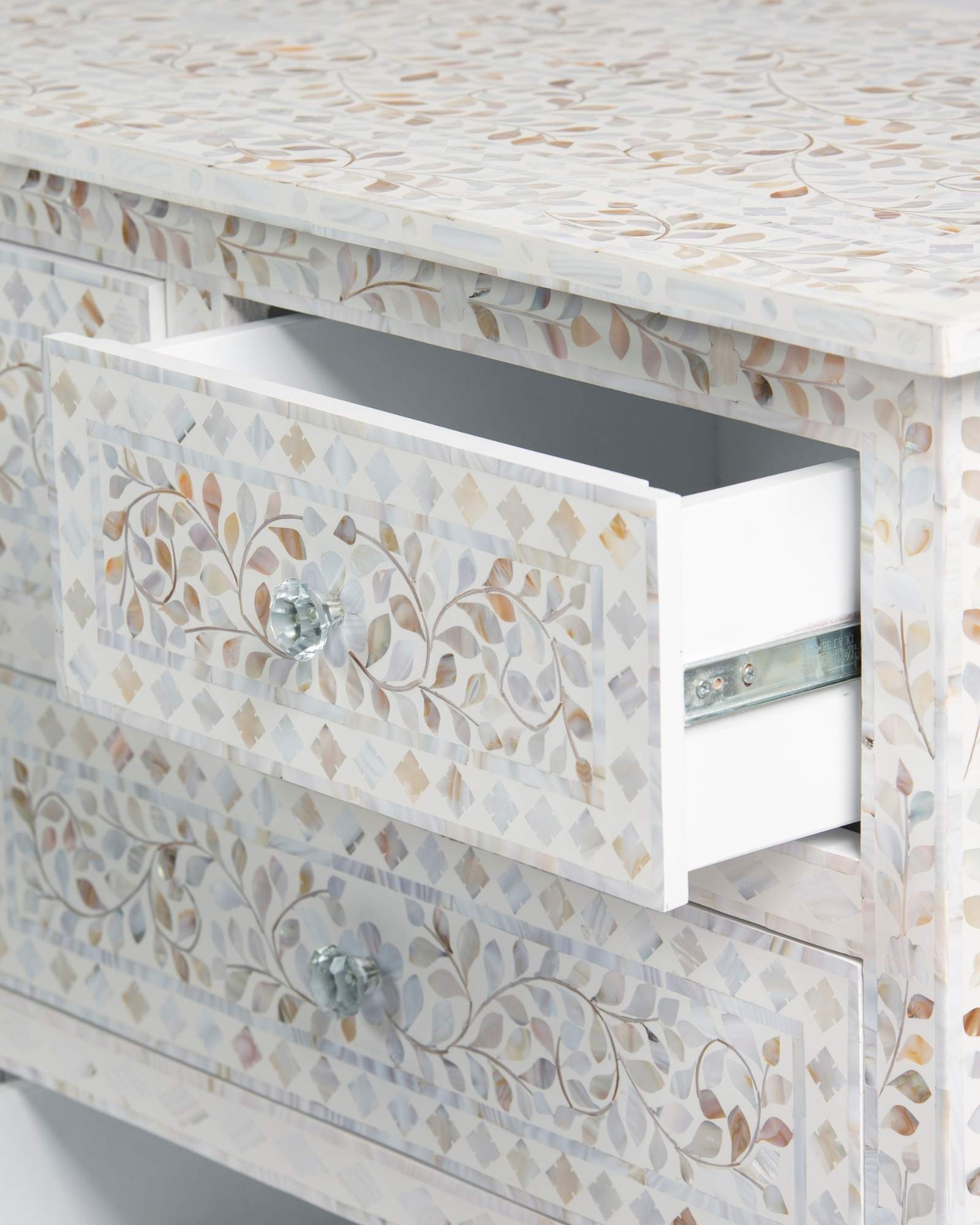 Mother of pearl inlay chest of drawers featuring intricate floral pattern in white and multitone, handcrafted furniture piece.
