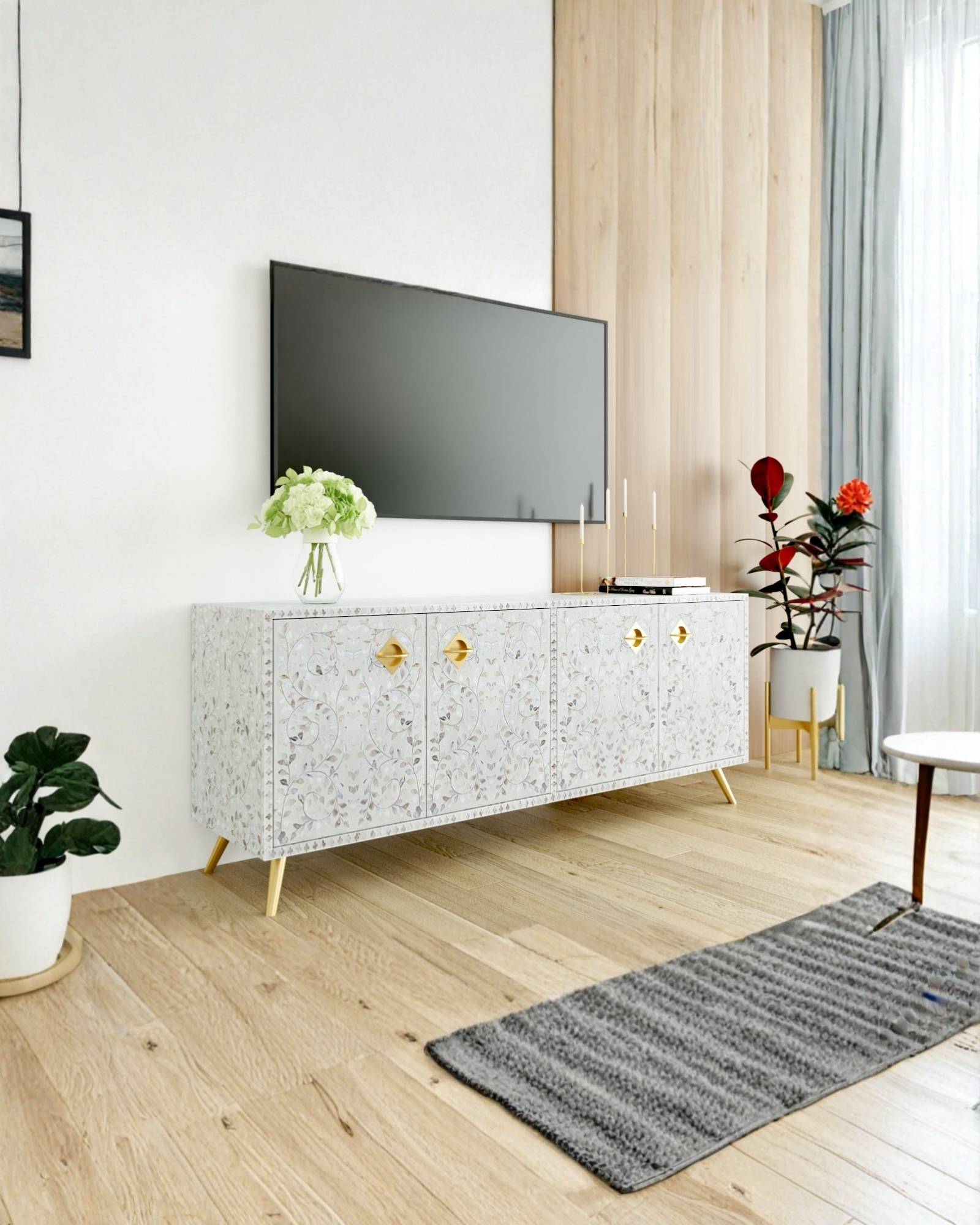 Handcrafted white TV Unit with intricate Mother of Pearl inlay, featuring a floral pattern and sleek metal legs. A luxurious storage solution for any space.