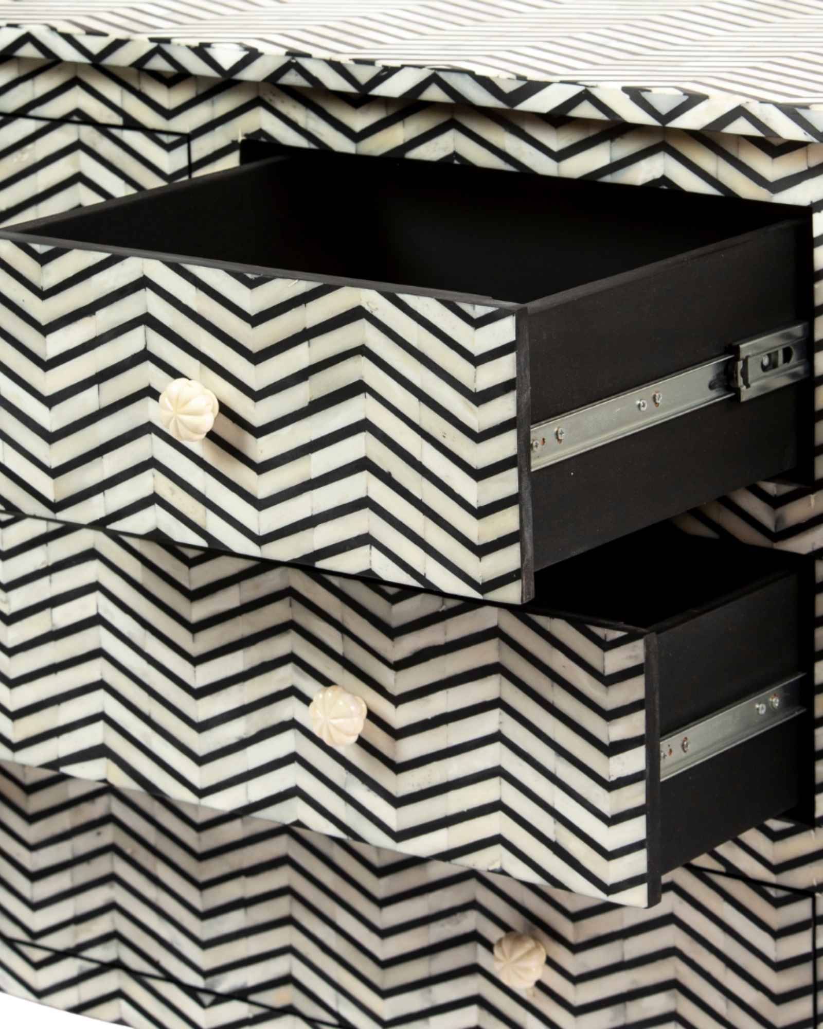 Featuring a Black Bone Inlay Chest of Drawer in chevron pattern, the Isra collection enhances your space with intricately handcrafted designs that elevate your home and living aesthetics.