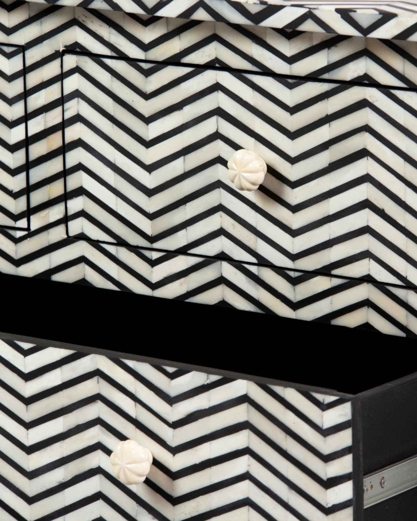 Featuring a Black Bone Inlay Chest of Drawer in chevron pattern, the Isra collection enhances your space with intricately handcrafted designs that elevate your home and living aesthetics.