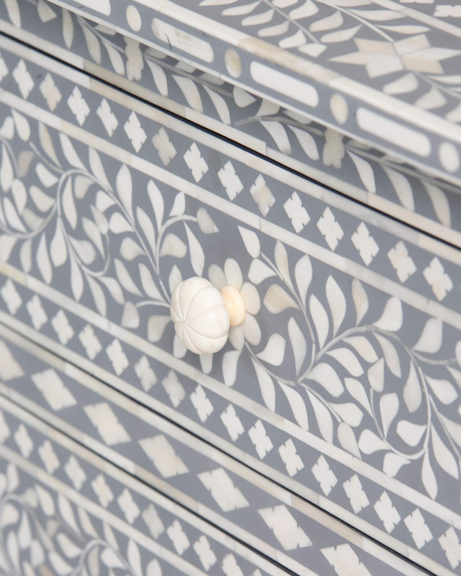 Bone inlay chest of drawers featuring intricate floral pattern in grey and white, handcrafted furniture piece.