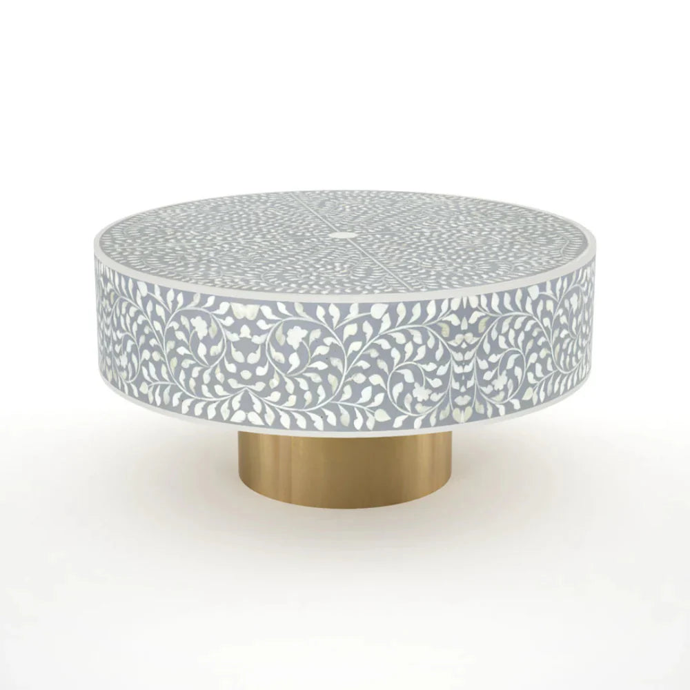 Round grey bone inlay coffee table with floral design and a gold base. Perfect for modern or elegant living room decor.