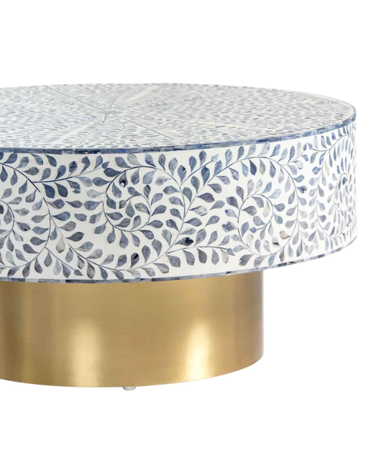 Handcrafted Jade coffee table featuring intricate blue bone inlay detailing with a round silhouette and brushed brass base.