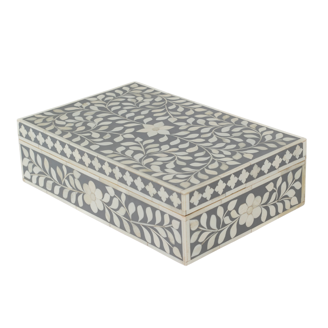 A soft grey decorative box crafted in bone inlay, combining subtle tones with intricate floral detailing.