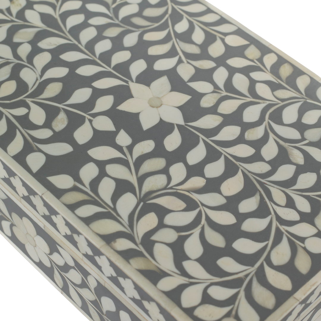 A soft grey decorative box crafted in bone inlay, combining subtle tones with intricate floral detailing.
