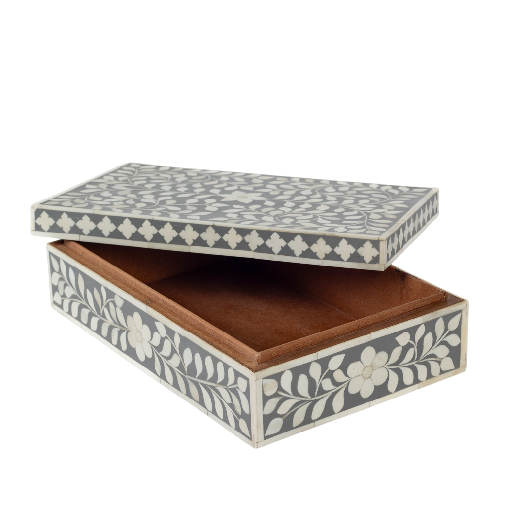 A soft grey decorative box crafted in bone inlay, combining subtle tones with intricate floral detailing.