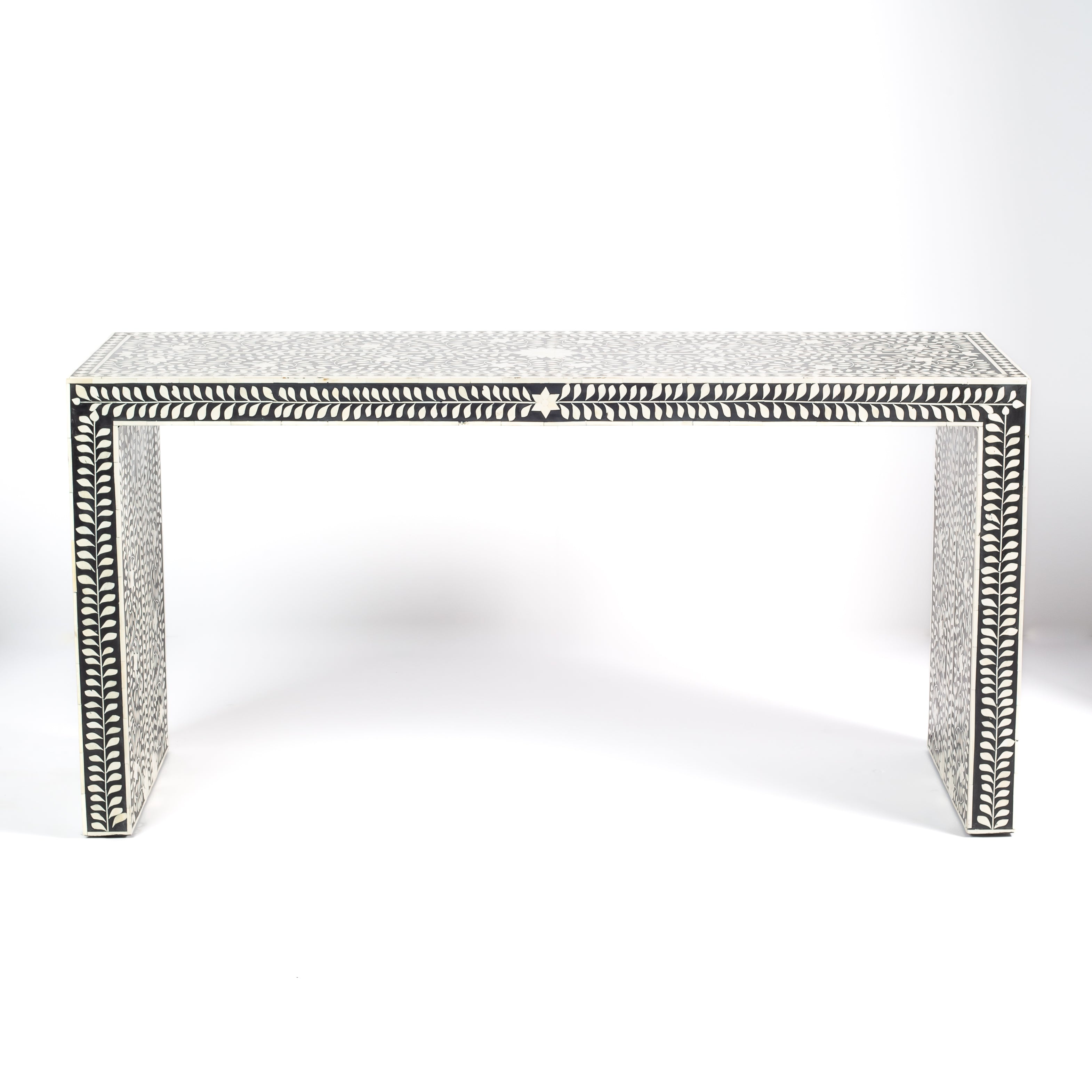Black bone inlay console table with floral and vine motifs, handcrafted by artisans and finished with intricate detailing across the surface.