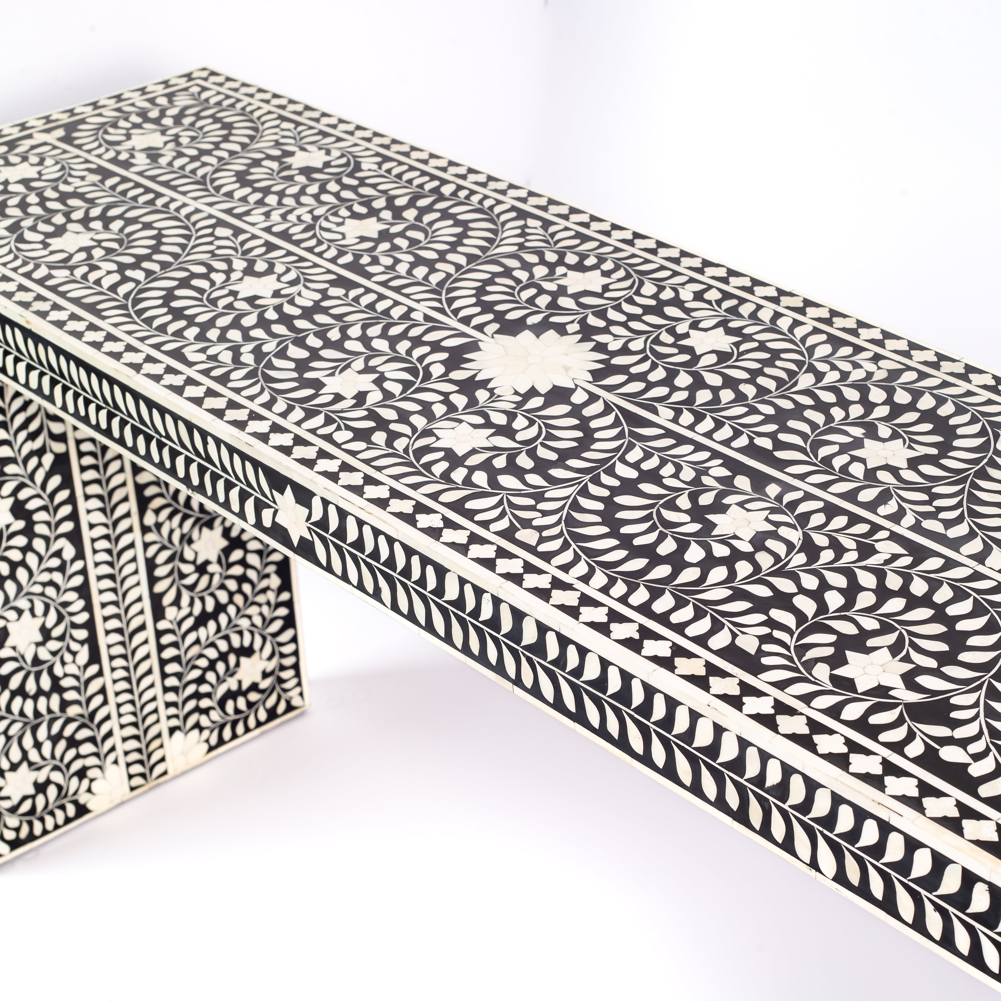 Black bone inlay console table with floral and vine motifs, handcrafted by artisans and finished with intricate detailing across the surface.