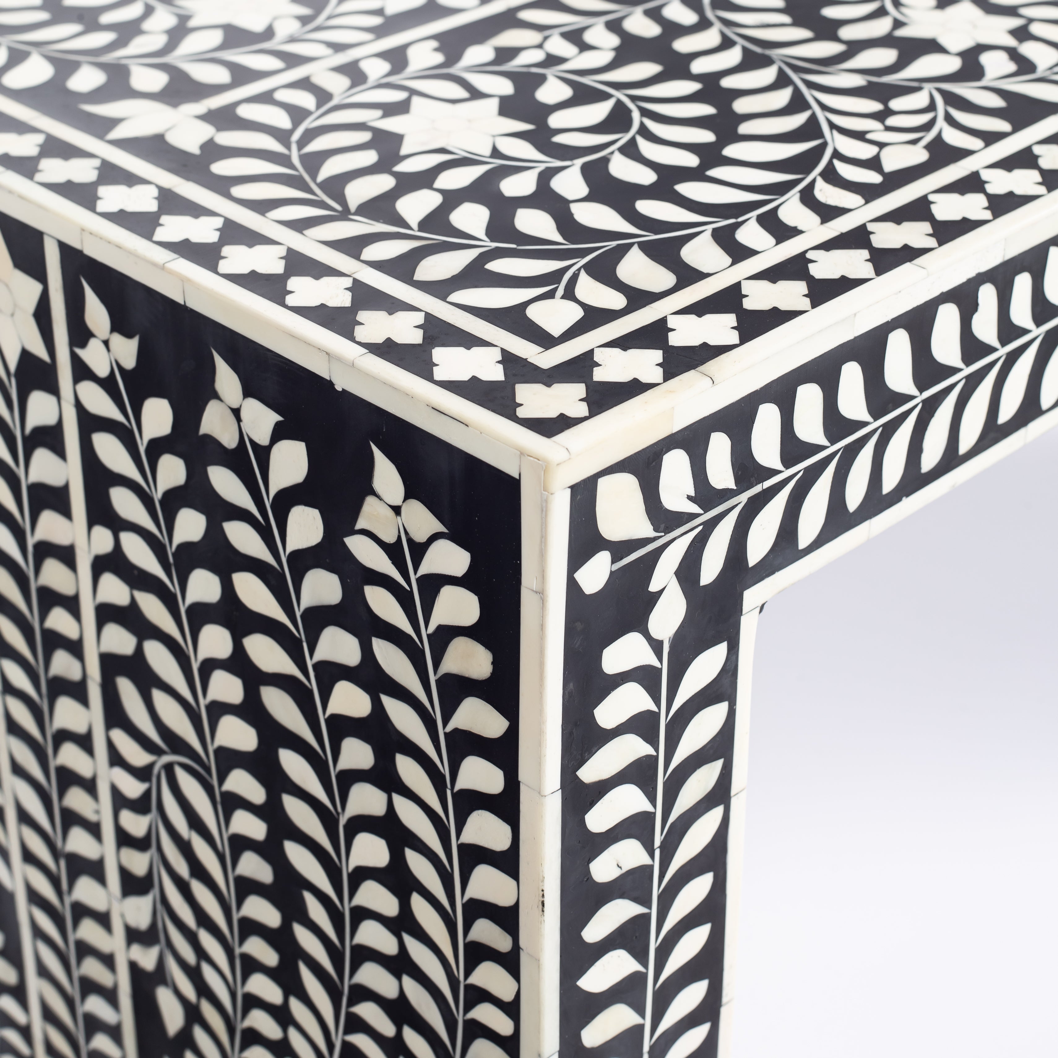 Black bone inlay console table with floral and vine motifs, handcrafted by artisans and finished with intricate detailing across the surface.