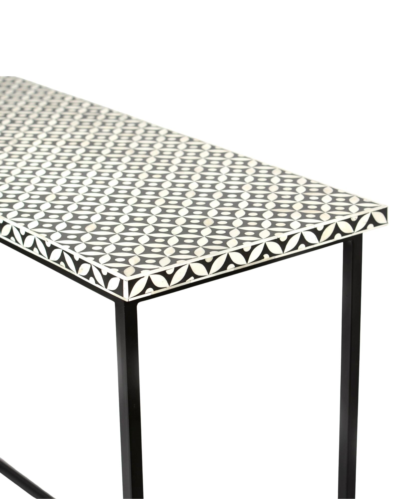 Bone inlay console table featuring geometric pattern in black and white with metal base, handcrafted furniture piece.