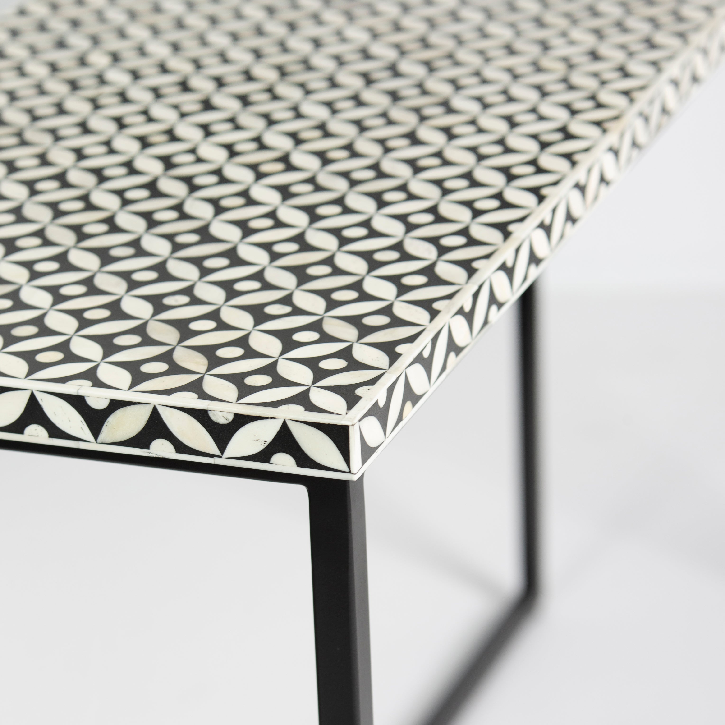 Bone inlay console table featuring geometric pattern in black and white with metal base, handcrafted furniture piece