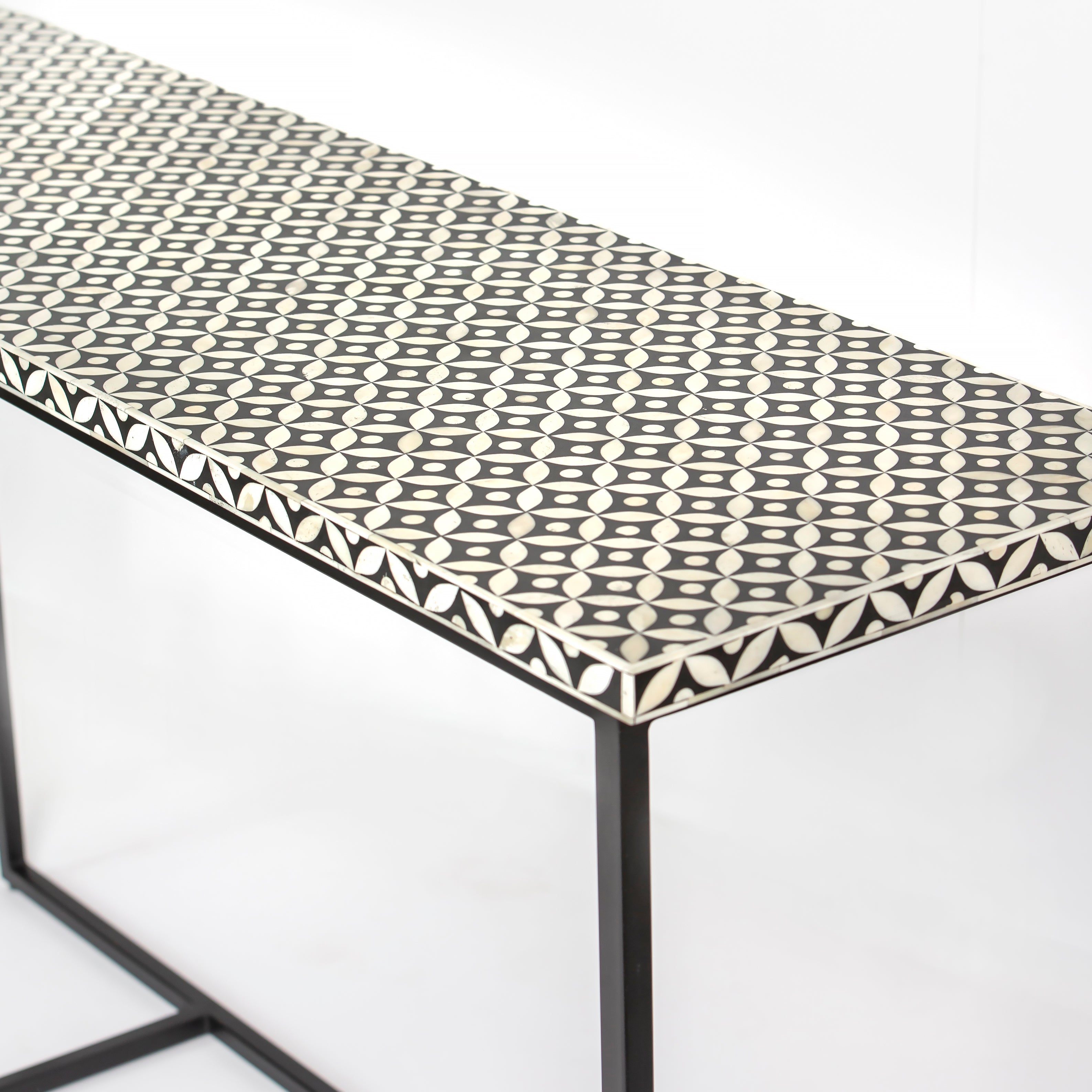 Bone inlay console table featuring geometric pattern in black and white with metal base, handcrafted furniture piece