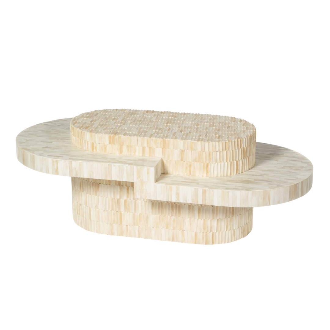 Sculptural bone carved coffee table with layered design in soft neutral tones, handcrafted with curved tiers and textured artisanal detailing.