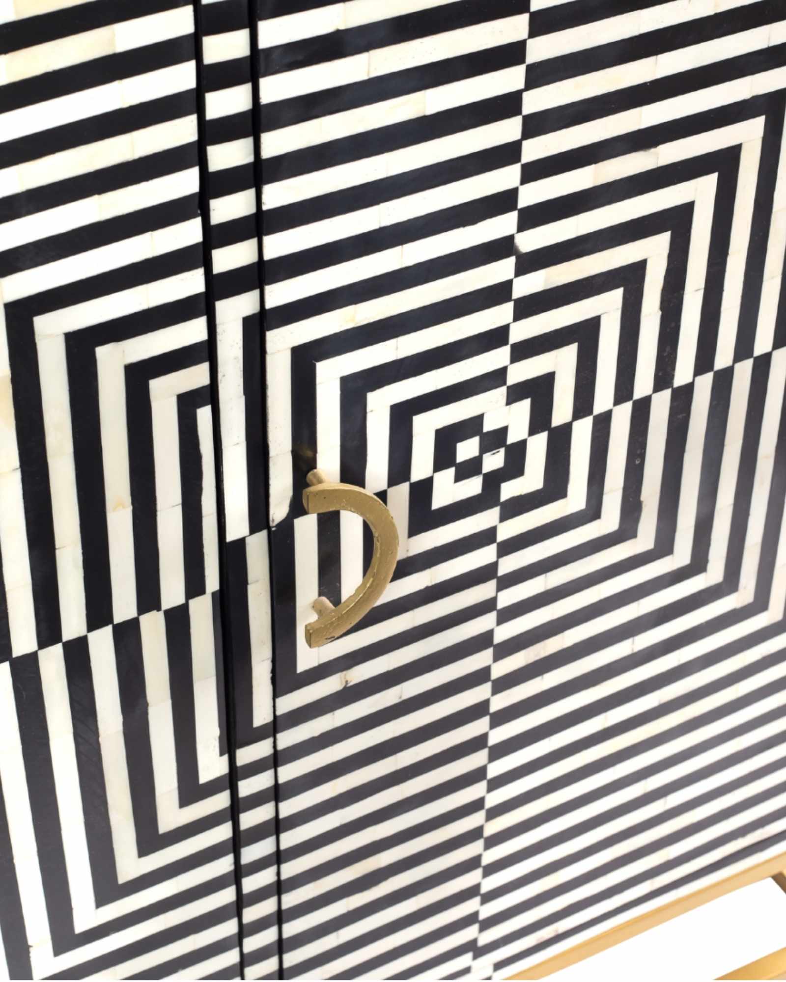 Black & White bone inlay cabinet in striped vine pattern, brass legs, and brass handles, handcrafted with spacious storage and artisanal charm.