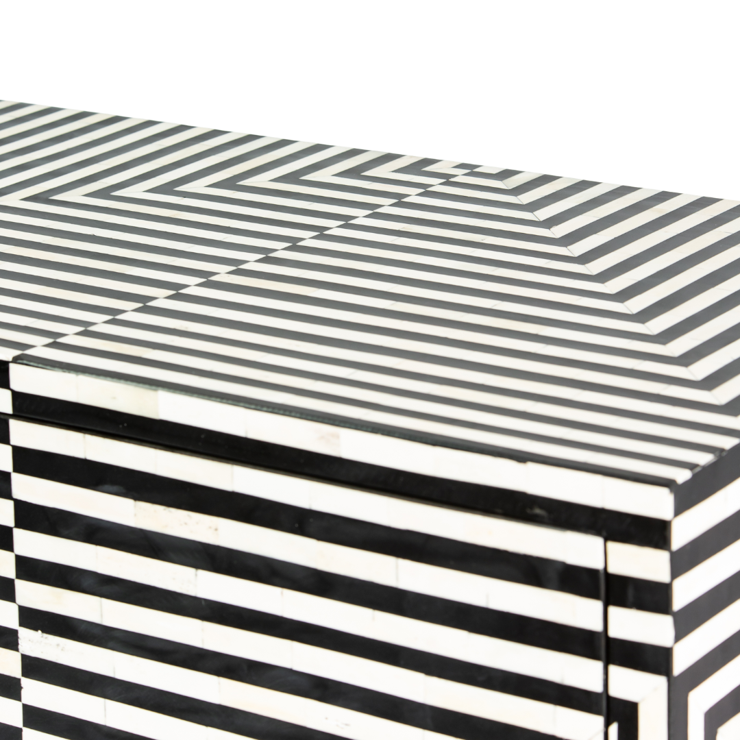 Black & White bone inlay cabinet in striped vine pattern, brass legs, and brass handles, handcrafted with spacious storage and artisanal charm.