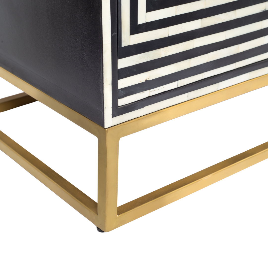 Black & White bone inlay cabinet in striped vine pattern, brass legs, and brass handles, handcrafted with spacious storage and artisanal charm.