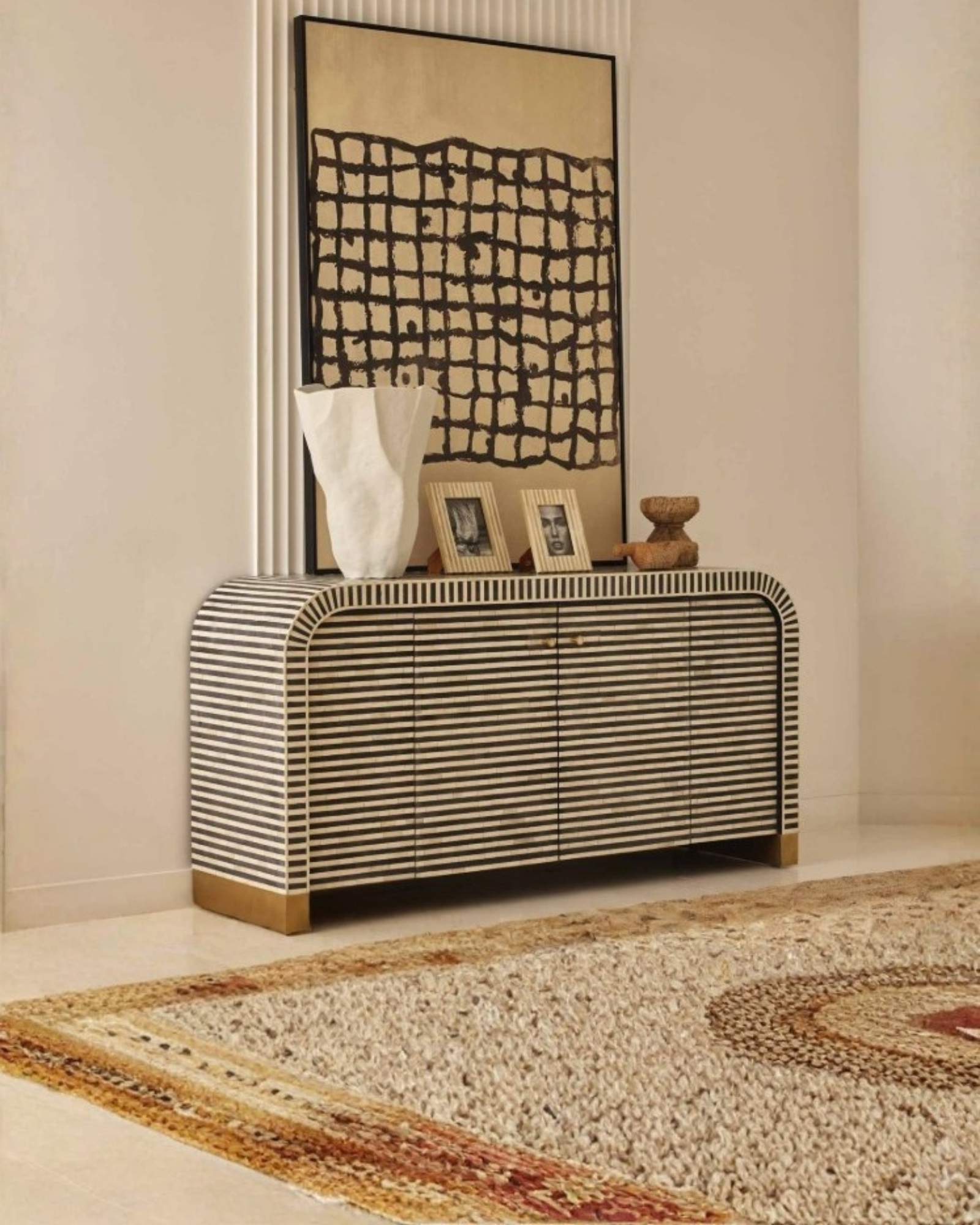 Handcrafted Black & White cabinet with intricate bone inlay, featuring striped pattern and sleek metal legs. A luxurious storage solution for any space.
