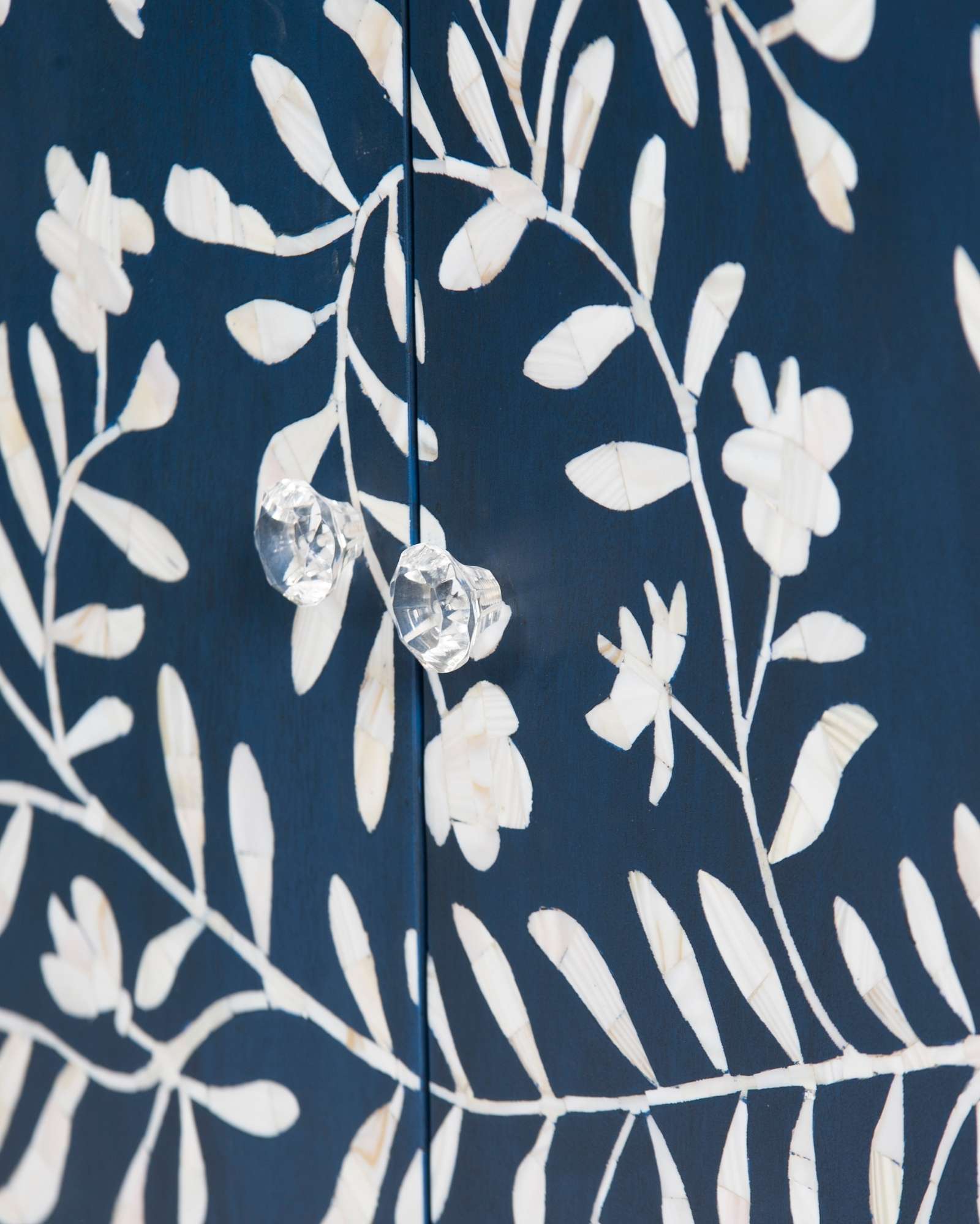 Mother of pearl inlay cabinet featuring intricate floral vine pattern in blue and white, handcrafted furniture piece.