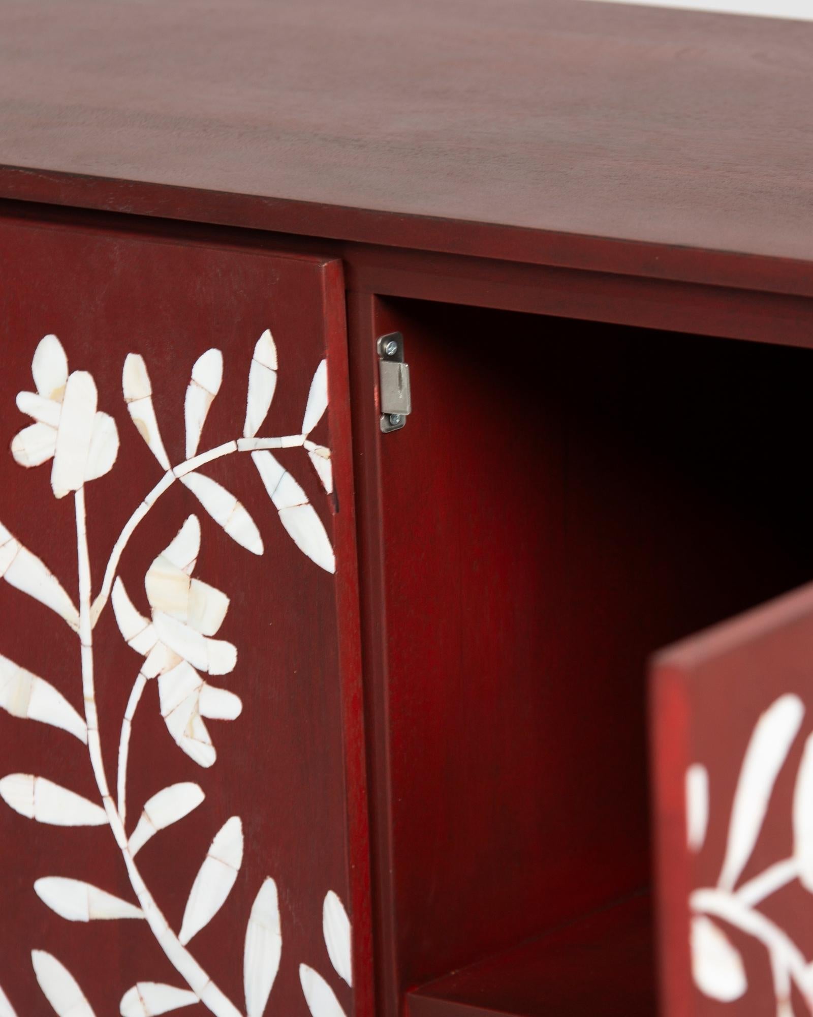 Mother of pearl inlay cabinet featuring intricate floral vine pattern in burgundy and white, handcrafted furniture piece.