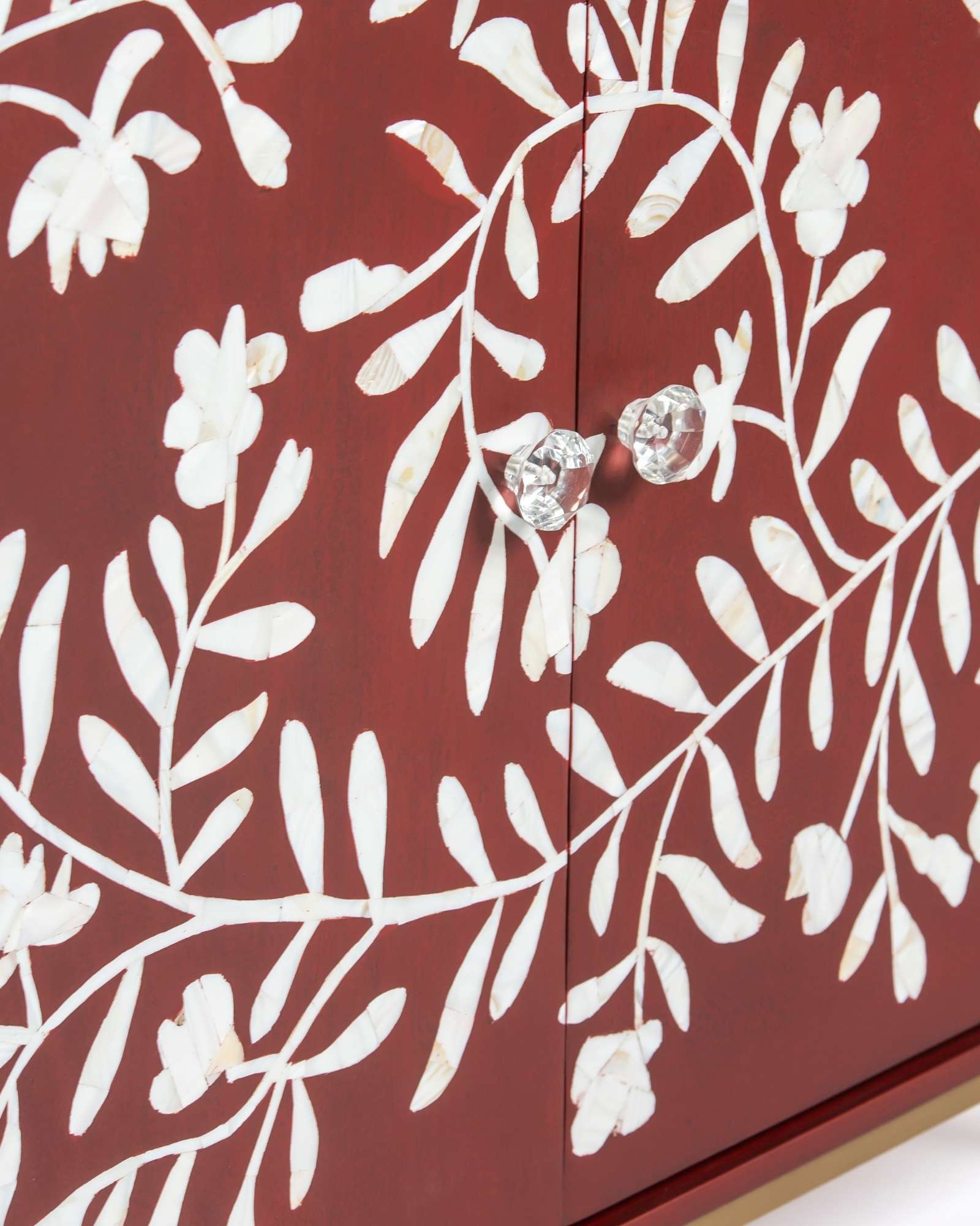 Mother of pearl inlay cabinet featuring intricate floral vine pattern in burgundy and white, handcrafted furniture piece.