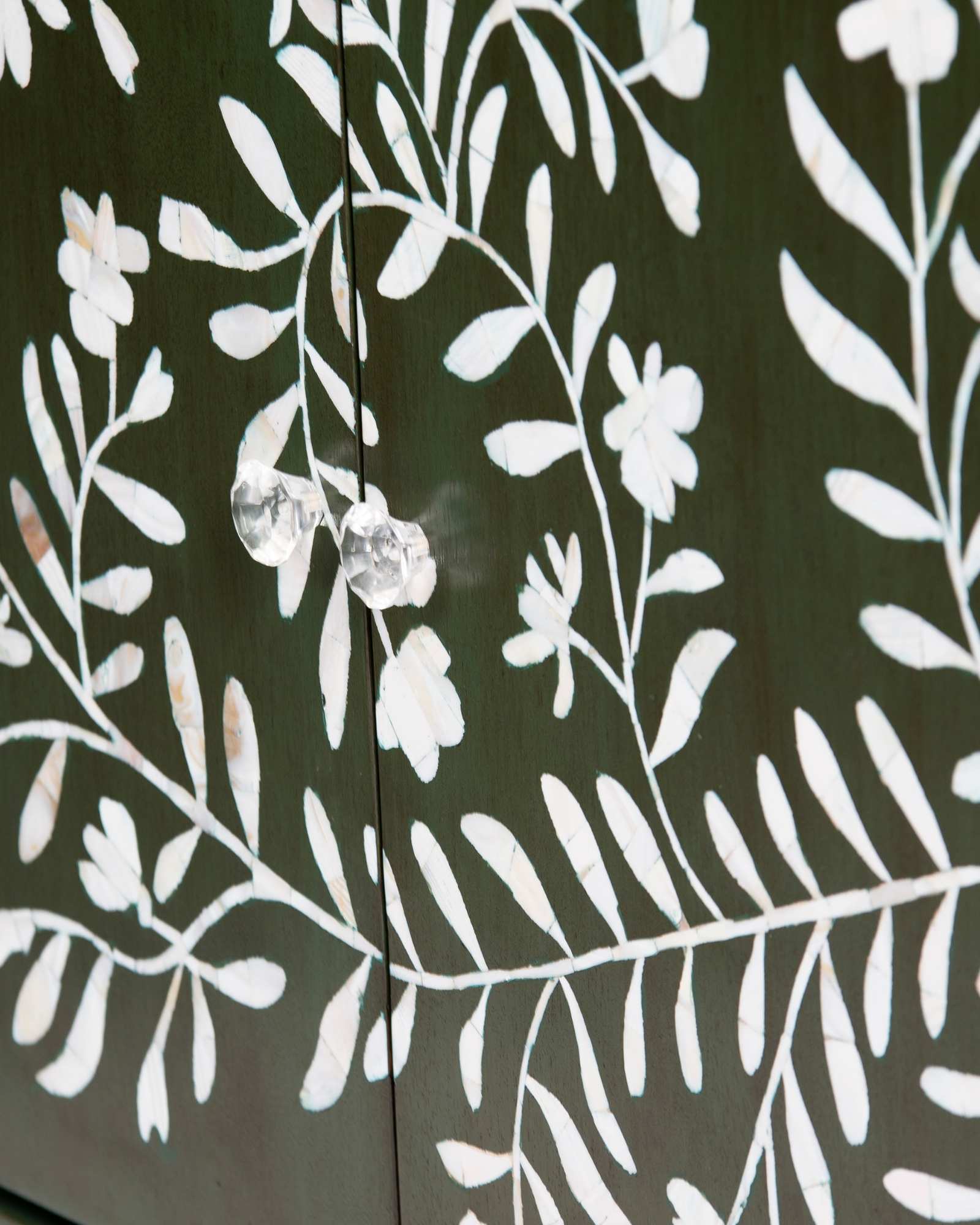 Mother of pearl inlay cabinet featuring intricate floral vine pattern in green and white, handcrafted furniture piece.