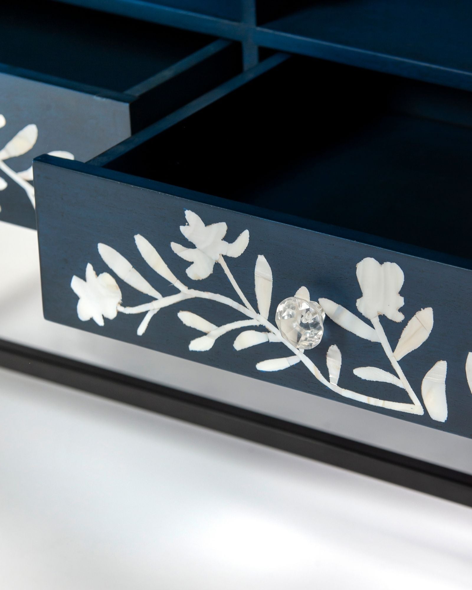 Mother of pearl inlay cabinet featuring intricate floral vine pattern in blue and white, handcrafted furniture piece.