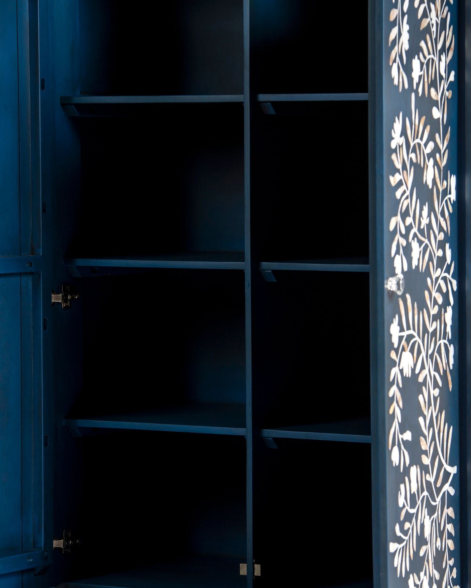 Mother of pearl inlay cabinet featuring intricate floral vine pattern in blue and white, handcrafted furniture piece.