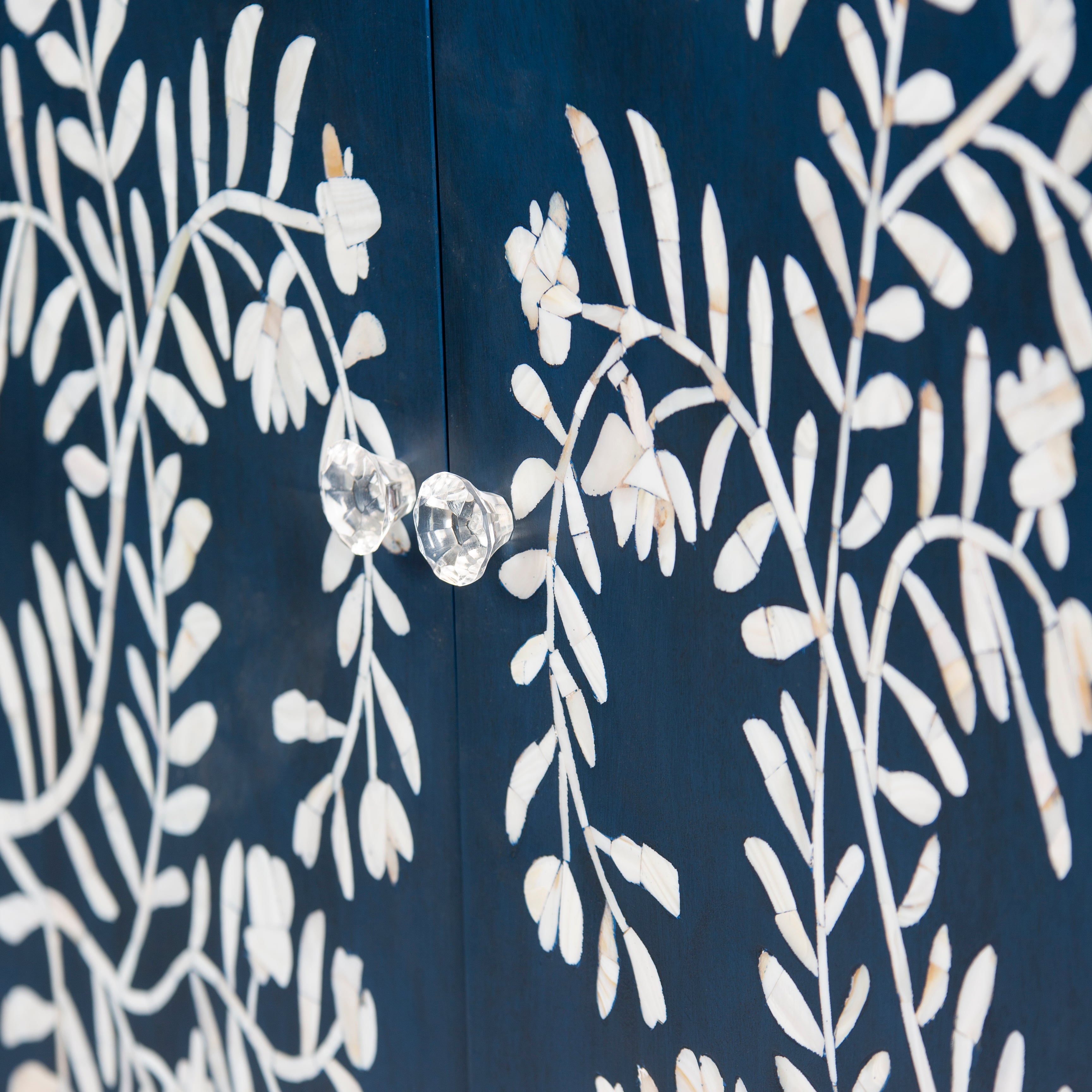 Mother of pearl inlay cabinet featuring intricate floral vine pattern in blue and white, handcrafted furniture piece