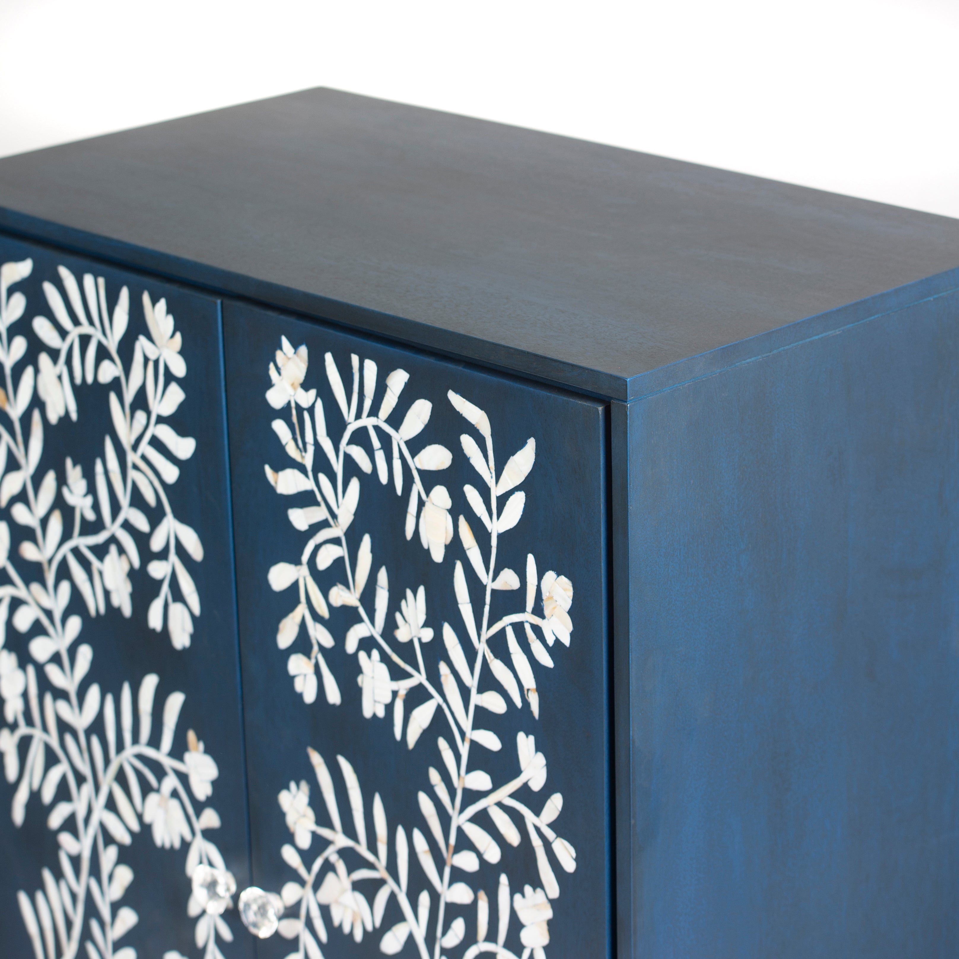 Mother of pearl inlay cabinet featuring intricate floral vine pattern in blue and white, handcrafted furniture piece