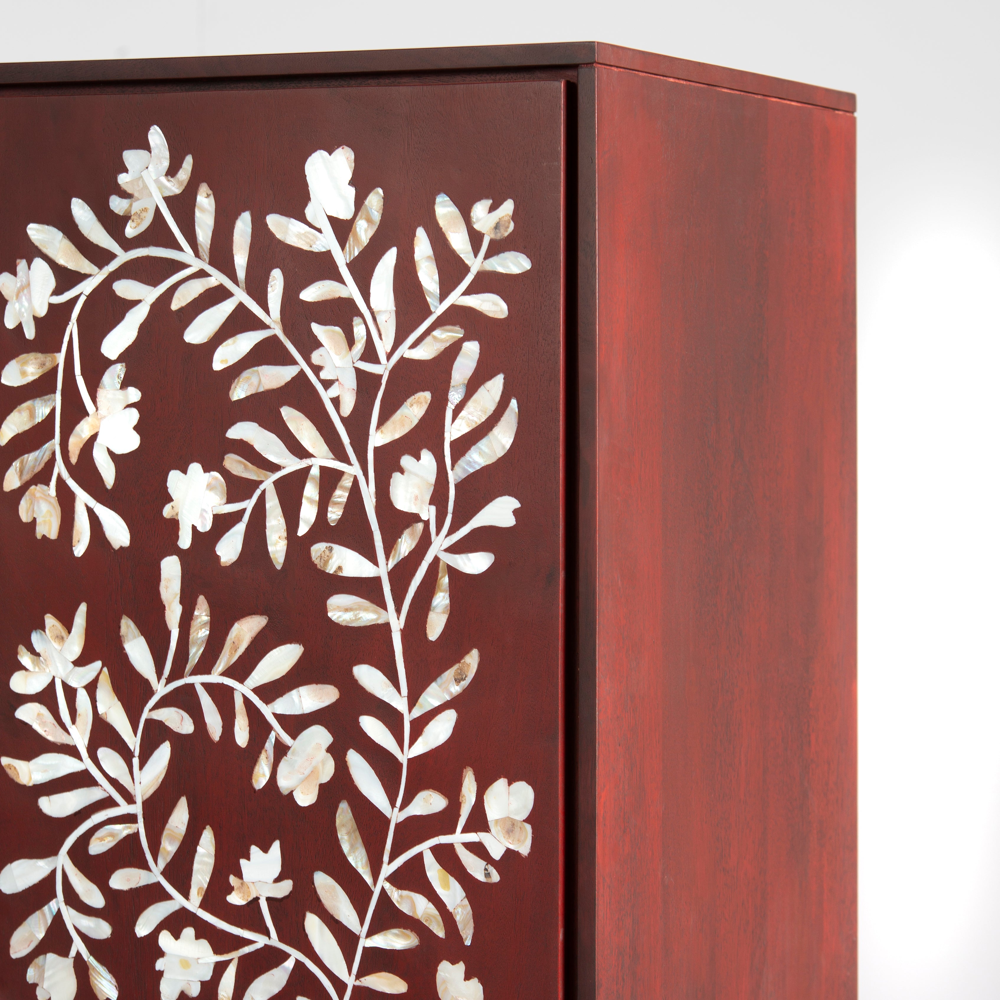 Mother of pearl inlay cabinet featuring intricate floral vine pattern in burgundy and white, handcrafted furniture piece