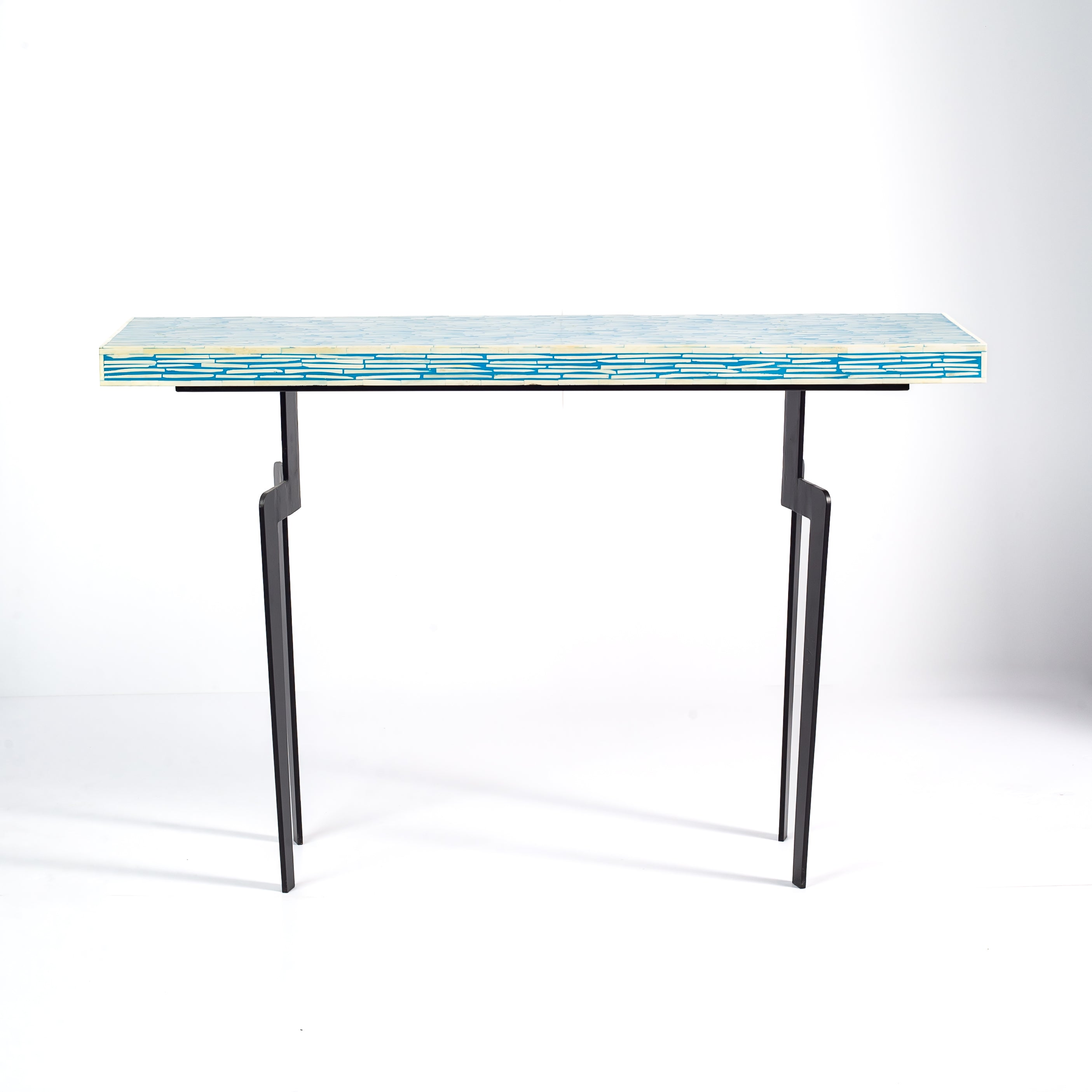 Console table with a blue and white patterned top on a white background