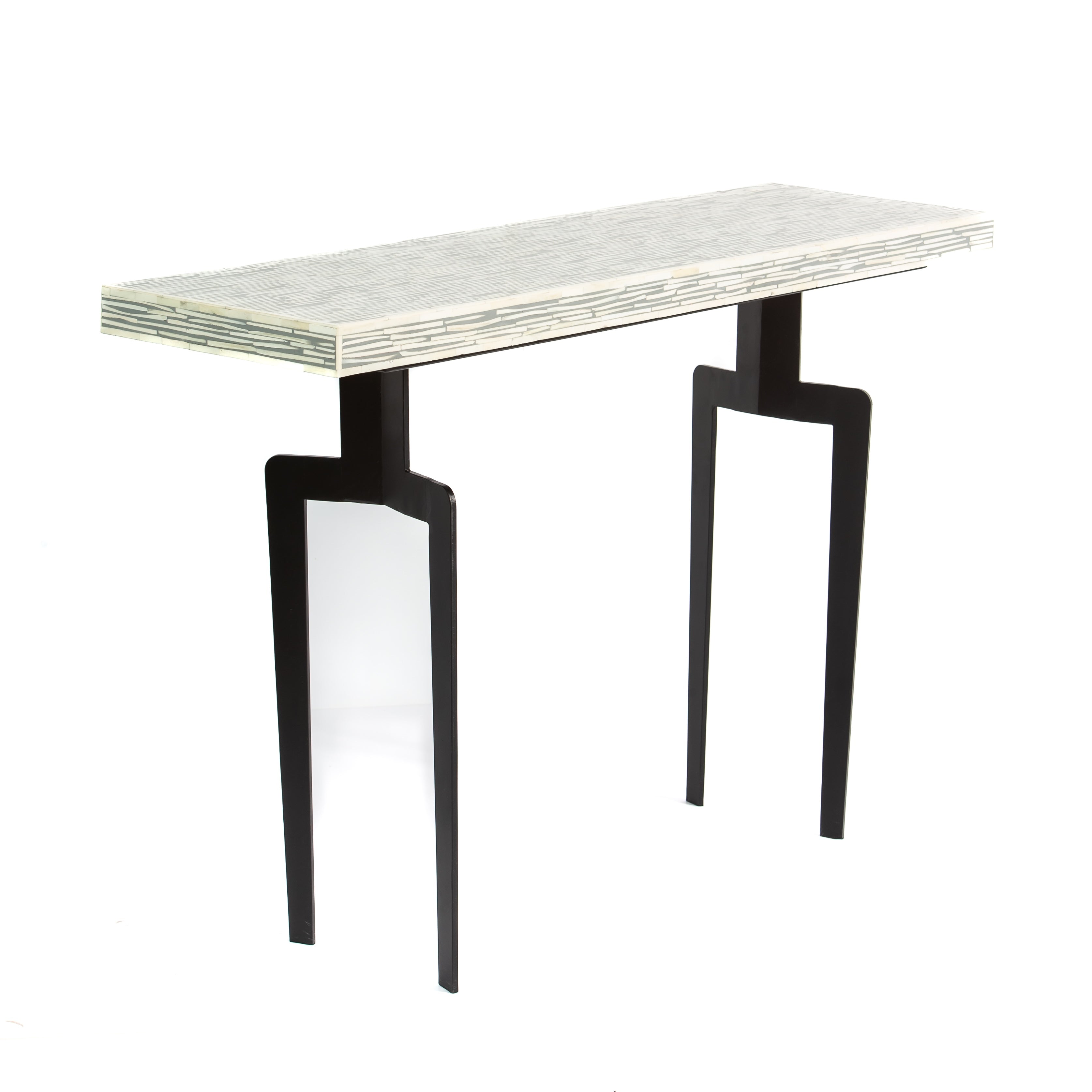 Table with bone inlay top and black legs on a white background